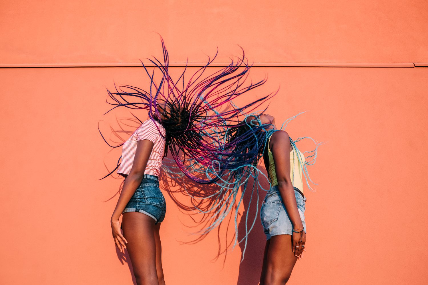 Two women with their hair in the air