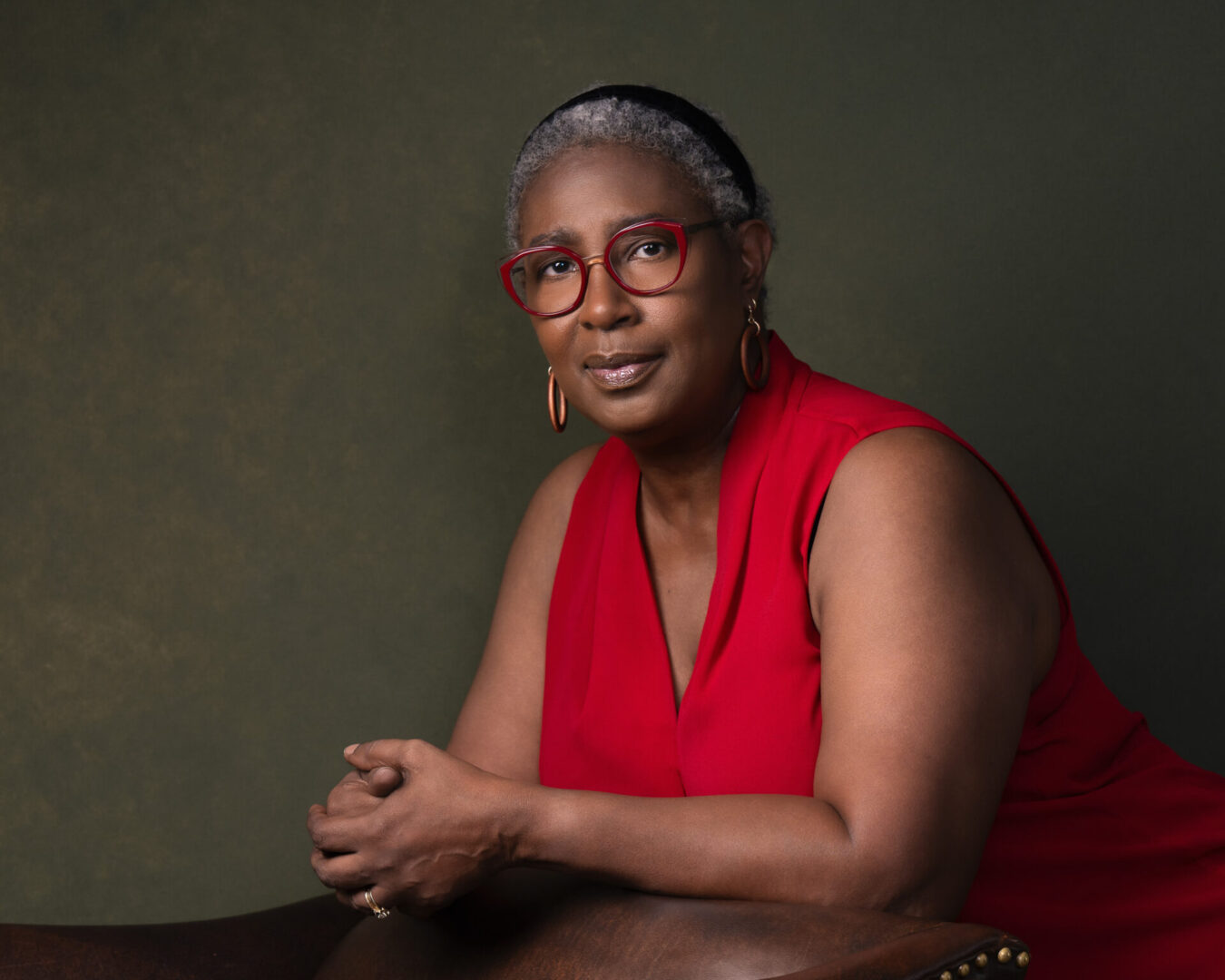 A woman in red is sitting on the chair