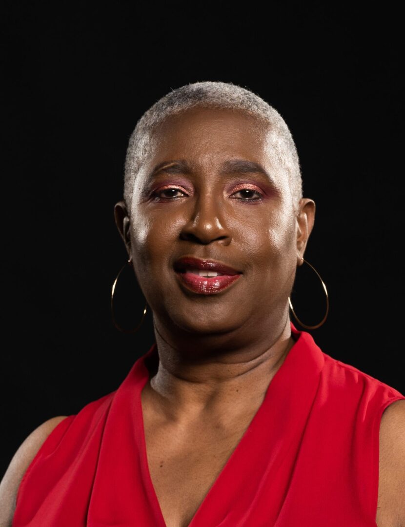 A woman in red shirt and black background