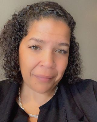 A woman with curly hair wearing black and white.