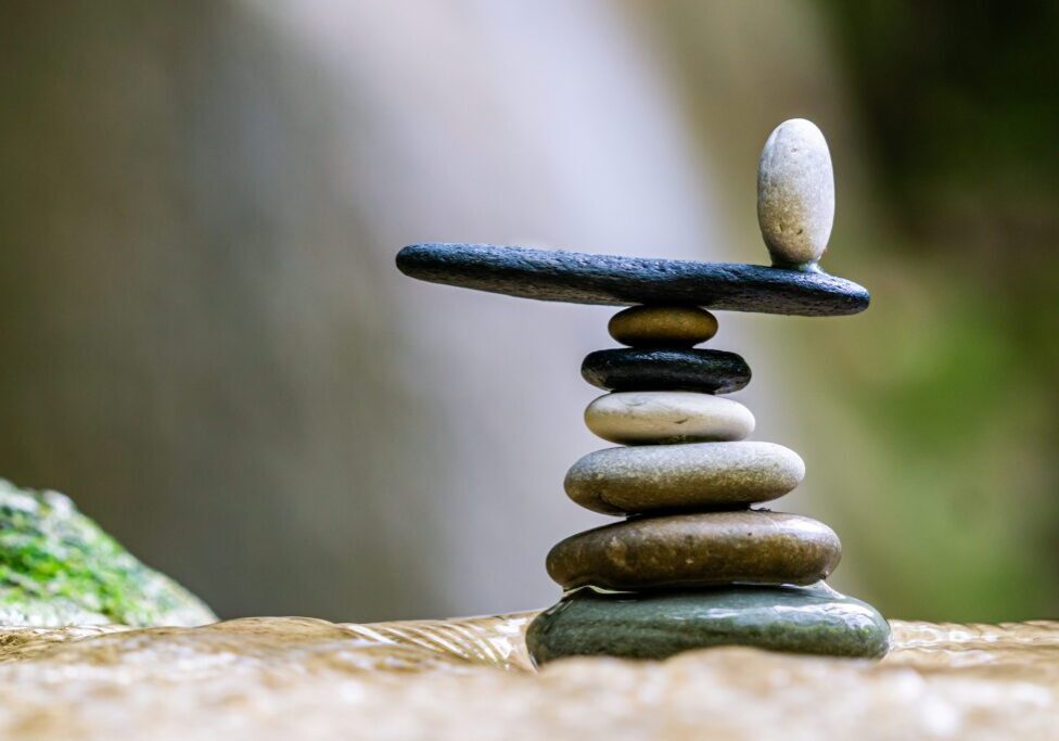 A stack of rocks with one rock balanced on top.