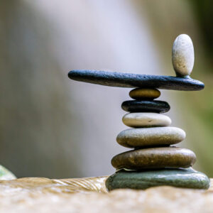 A stack of rocks with one rock balanced on top.